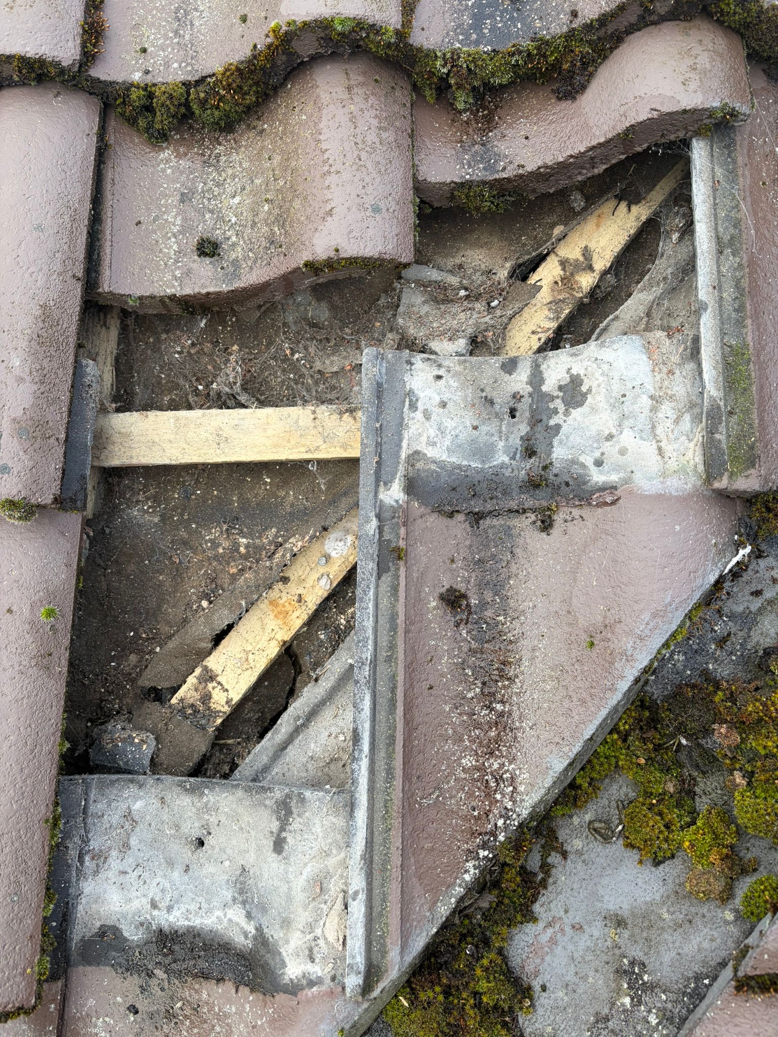 Storm-displaced roof tiles in Holt, Norfolk exposing timber battens