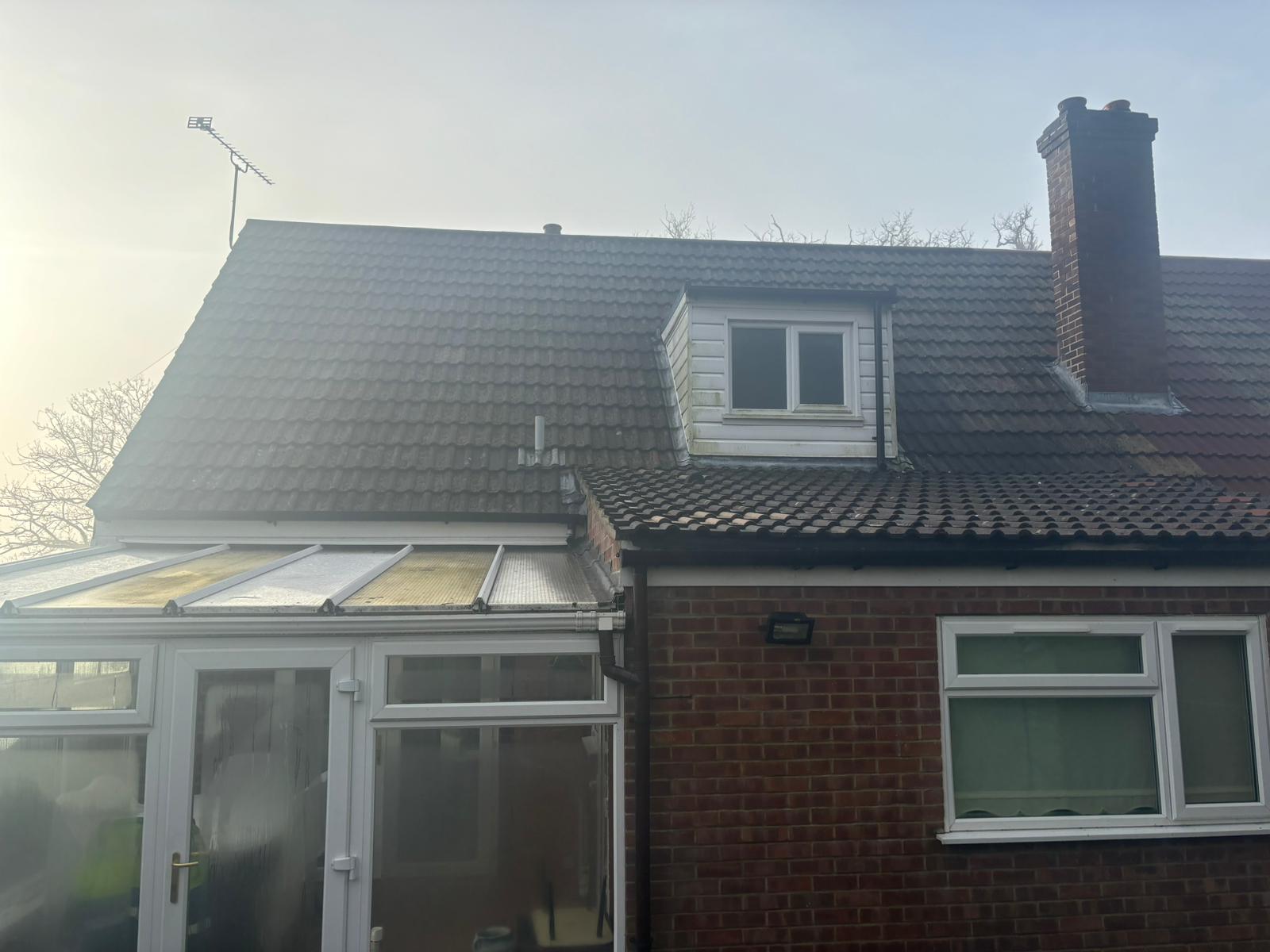 Overview of a bungalow roof in Roughton, Norfolk with dormer window before chimney repair works began