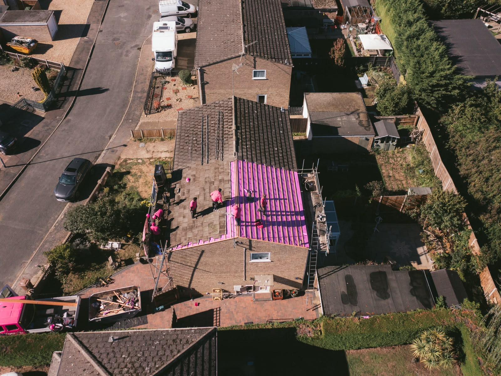 High aerial view of the street showing the roof fully covered in new membrane and battens
