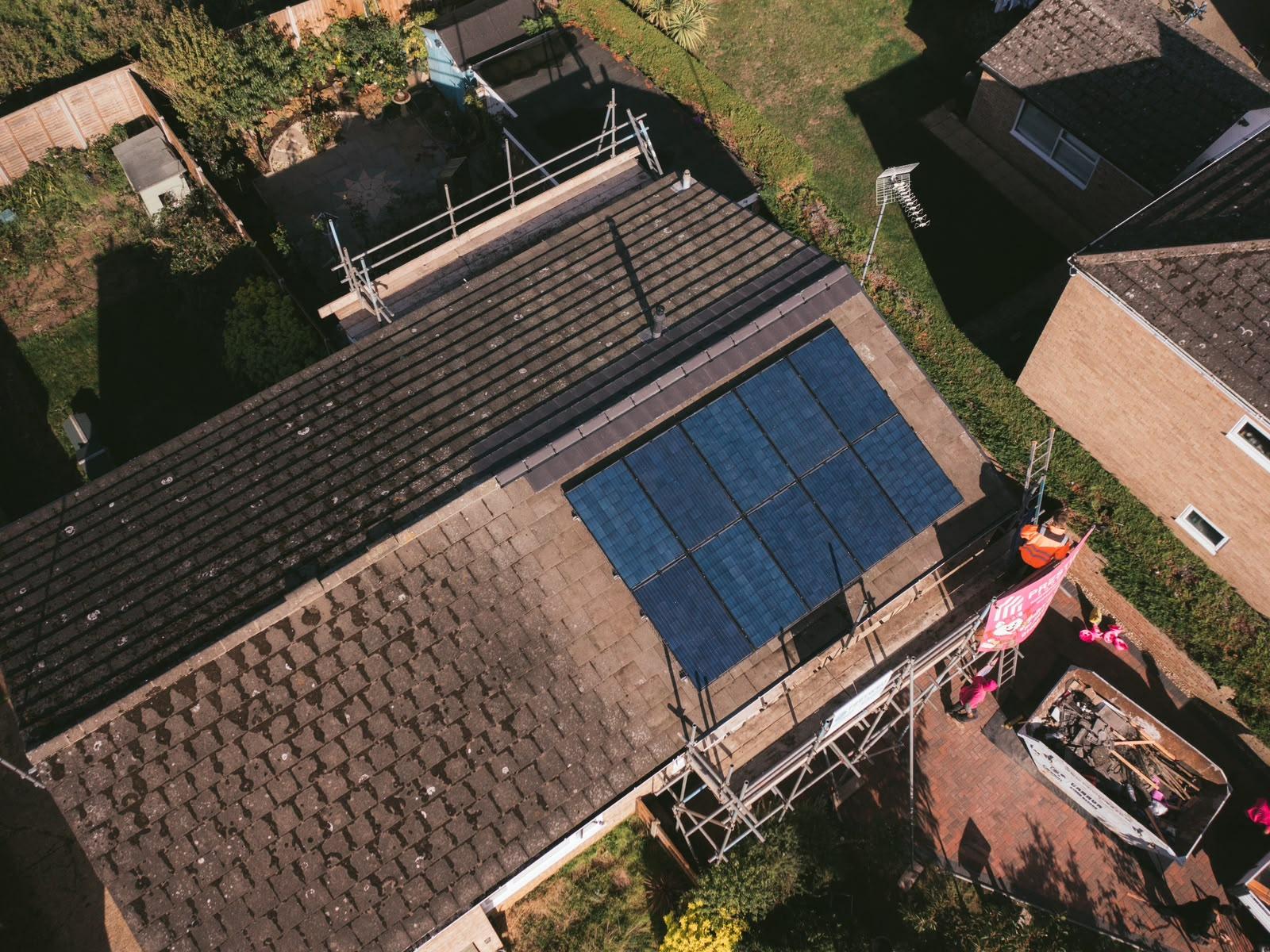 Drone view of the mossy original roof and solar panels ahead of the roof replacement